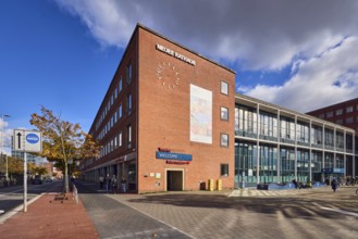 New town hall, brick building, brick architecture, modern architecture, façade with windows, trees,