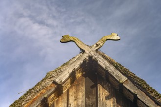Typical traditional pediment with the symbol of two crossed snakes in the open-air museum near