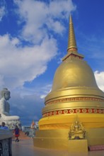 People, Buddha statue, chedi in Wat Tam Sua monastery, which is partly on the top of a mountain,