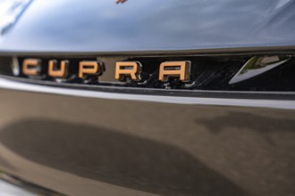 Detailed view of shiny lettering in copper paint on a car, Cupra electric car, e-car sharing, Calw,