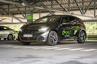 Carsharing car in parking garage, modern design with LEASER branding on the sides, Cupra electric