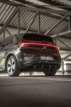 Back view of a black car under a covered parking lot, electric car Cupra, e-car sharing, Calw,