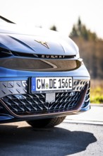 Close-up of the front of a modern black car with shiny body, electric car Cupra, e-car sharing,