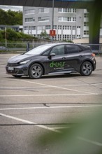 Black car sharing car parked in vacant area, modern city vehicle, Cupra electric car, e-car