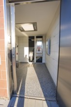 Modern bathroom with tiled floor and wall mirror, Weil der Stadt railway station, Germany