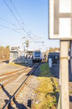 Train arrives at station, bright daylight, modern track system, Weil der Stadt station, Germany