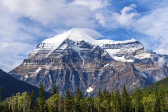 Mount robson, towering in the canadian rockies, showcases its snow capped summit and rugged slopes