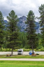 Recreational vehicles and cars parked in a campground near majestic mount robson, the highest peak