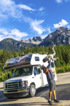 Father lifting his son in the air, celebrating their adventure in mount robson provincial park,