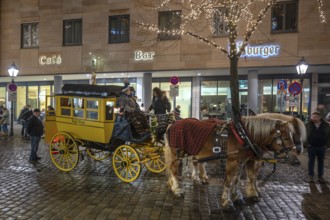 Horse-drawn carriage ride in a historic stagecoach at Chriskindlesmarkt, Hauptmarkt, Nuremberg,