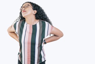 Afro woman with spine problems isolated. Young woman with back pain. Lumbar problems concept.