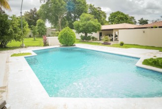 Beautiful crystal clear home pool. A crystal clear home swimming pool on a sunny day, Concept of