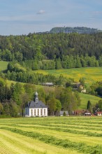 Church and houses in the village of Schwarzbach, in the back forest and blooming meadows, town of