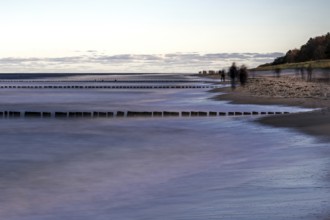 Grooing in the sea, people on the beach, evening light, long exposure, Zingst,