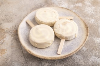 ?hocolate Ice cream in white glaze, on brown concrete background, side view, close up, minimalism