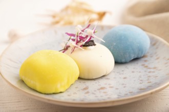 Japanese Mochi Cakes on white wooden background and linen textile, side view, close up, selective