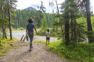 Mother and son enjoying a leisurely hike along a scenic banff national park trail, surrounded by