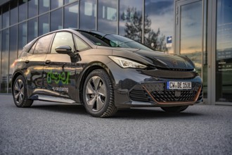 Car at dusk with reflection in a parking lot, Deer E-Car Sharing, Cupra electric car, Böblingen,