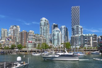 Modern skyline of vancouver. British columbia. With high rise residential buildings and a motorboat
