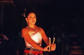 Young woman performing a traditional candle dance, Ko Phuket, Thailand, December 2002, vintage,