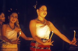Young woman perform a traditional candle dance, Ko Phuket, Thailand, December 2002, vintage, retro,