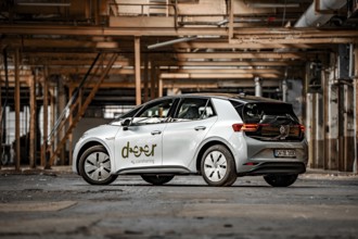 A modern electric car in an industrial environment with metallic structures, Deer E-Car Sharing,