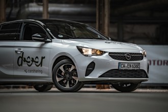 Close up view of a white Opel car sharing car with focus on headlights, Deer E-Car Sharing,