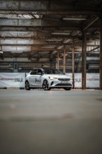 Opel car sharing vehicle parked in empty industrial building, Deer E-Car Sharing, Motorworld