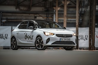 Opel car sharing car in modern factory building, visible from the front, Deer E-Car Sharing,