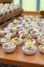 Various small bowls of dim sum arranged on a wooden table, Christmas party Dekra Congresshotel