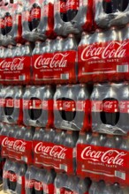 0.5 half liter plastic PET bottles stacked in plastic packs with sugary caffeinated beverage soft