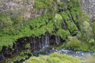River and waterfalls surrounded by lush vegetation and rocky gorge, Dashbashi gorge and waterfall,