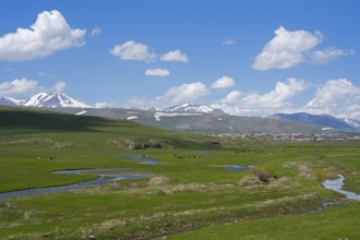 Wide landscape with meadows, rivers and snow-capped mountains, landscape near Saghamo,