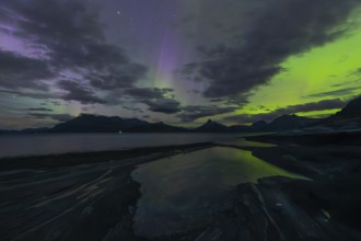 The Vestfjord in Nordland, Norway, has an enchanting atmosphere at night. Dark clouds and vivid