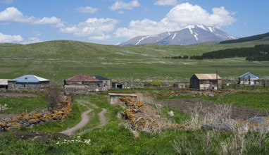 Dirt roads in a village with mountain views and snowy peaks in the distance, Jigrasheni, Didi Abuli