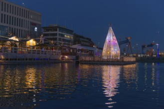 Christmas decoration in Kiel at the boat harbor, festive lighting, glow of lights, evening,
