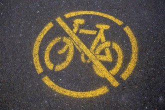 Yellow no cycling sign spray painted on tarmac path surface, Horniman, Museum, Forest Hill, London,