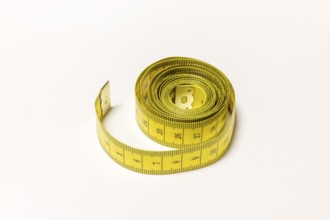 Yellow rolled up tape measure with visible numbers, Germany