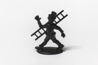 Black figure of a chimney sweep with cylinder and ladder as a lucky charm, Germany