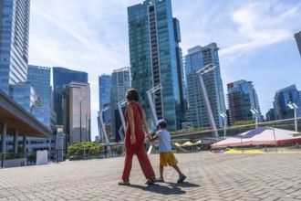 Mother and son holding hands walking in downtown vancouver, british columbia, canada, enjoying a