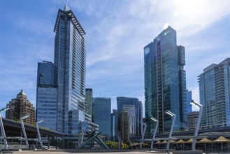 Sunlight illuminates modern skyscrapers and office buildings in vancouver, british columbia,