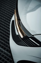 Close-up of a white car focusing on the modern headlight design, Deer E-Carsharing, Renault Megane,