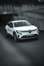 White modern SUV drives out of an underground car park on asphalt ground, Deer E-Carsharing,