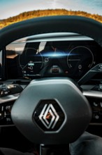 Interior view of an electric car with display and steering wheel, blue light section, Deer