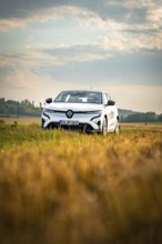 A white car is parked in a field under a wide, clear sky, Deer E-Carsharing, Renault Megane, Calw,