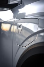 Close-up of a shiny car gas cap with logo and reflections, Deer E-Carsharing, Renault Megane, Calw,