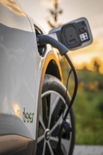 Electric car is charged at a charging station during autumn sunset, Deer e-Carsharing, Renault