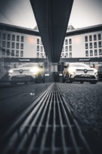 Car reflected in a modern building at gray dusk, Deer E-Carsharing, Renault Megane, Calw, Germany