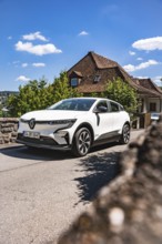 White car on a village road under blue sky in sunshine, Deer E-Carsharing, Renault Megane, Calw,