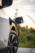 Electric car is charged at a charging station at sunset, Deer e-Carsharing, Renault Megane, Calw,